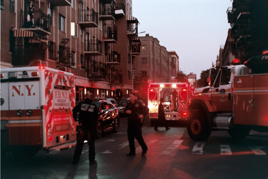 a group of emergency vehicles parked on the side of a road.