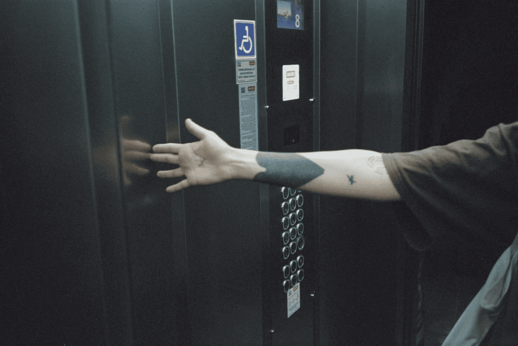 a man's arm with a tattoo on his arm reaching into a locker.
