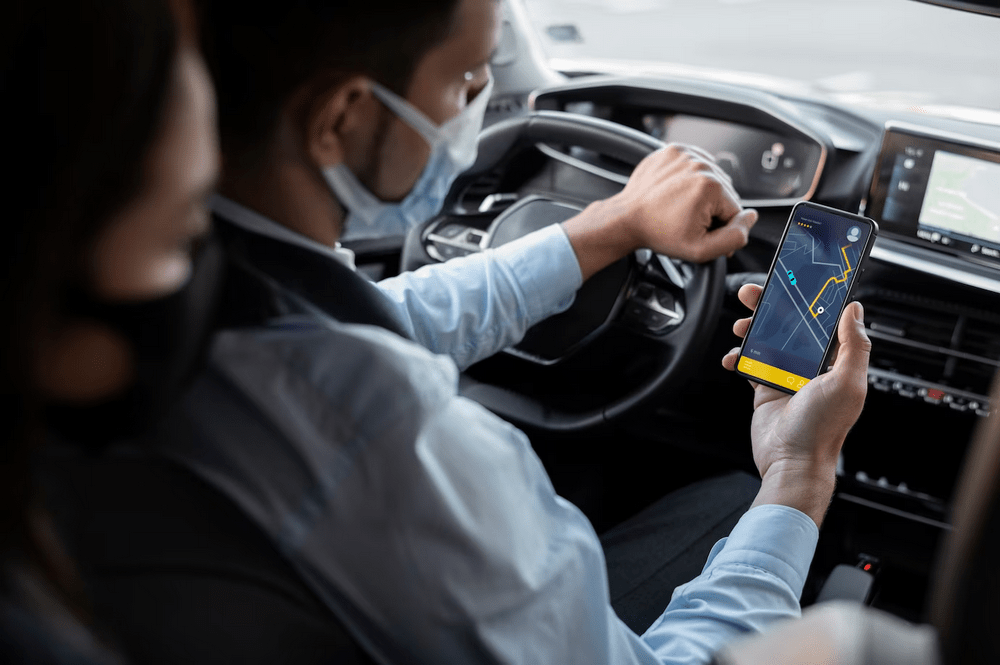 a man wearing a face mask while driving a car.