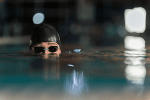 a close up of a person wearing a swimming cap and goggles.
