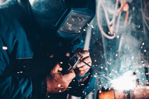 a welder working on a piece of metal.