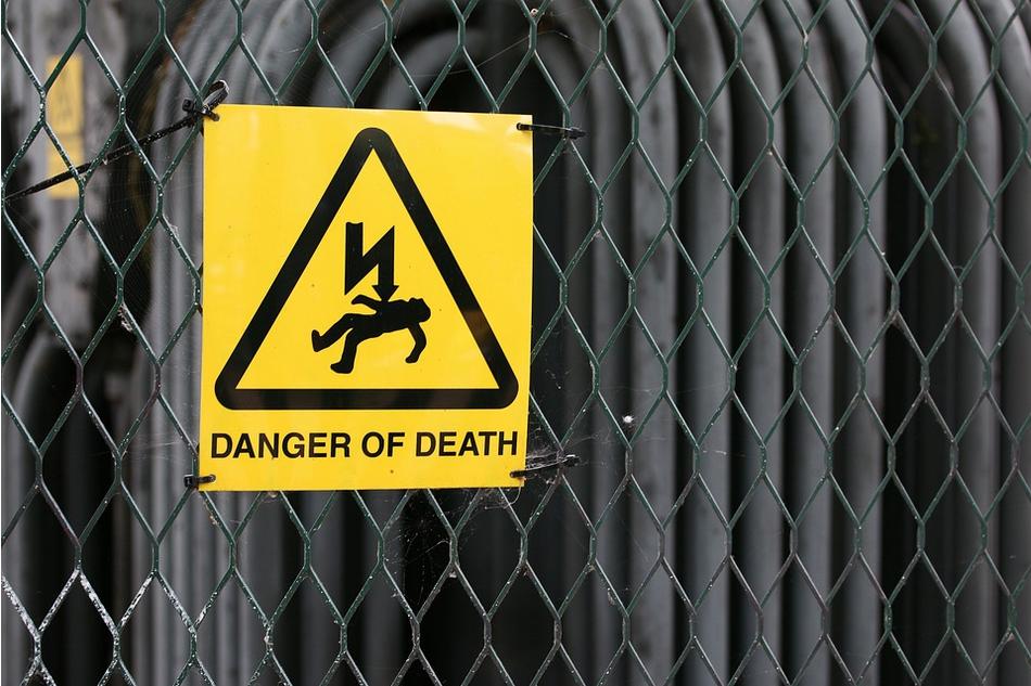Construction fence with danger of death sign, emphasizing the potential injuries.