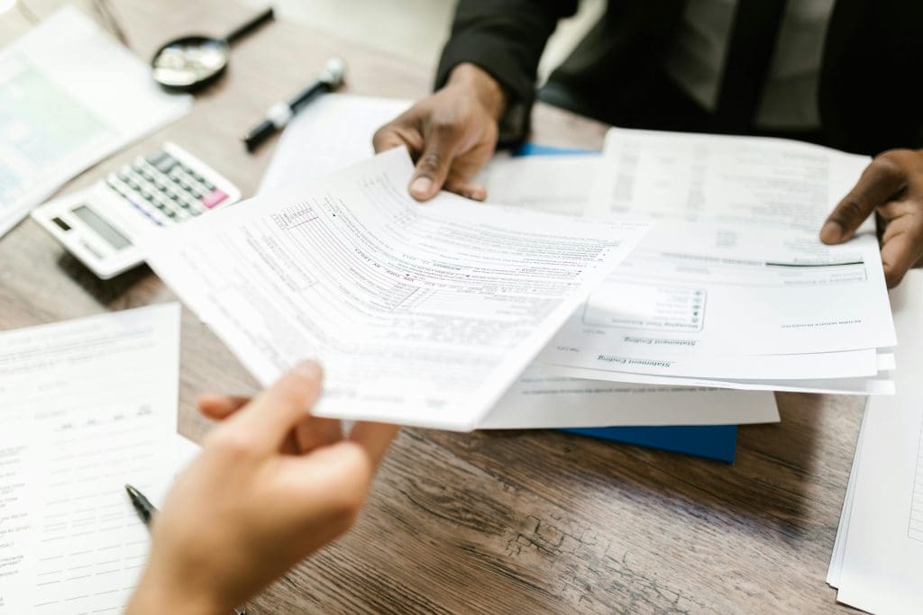 Liability papers being handed from lawyer to client