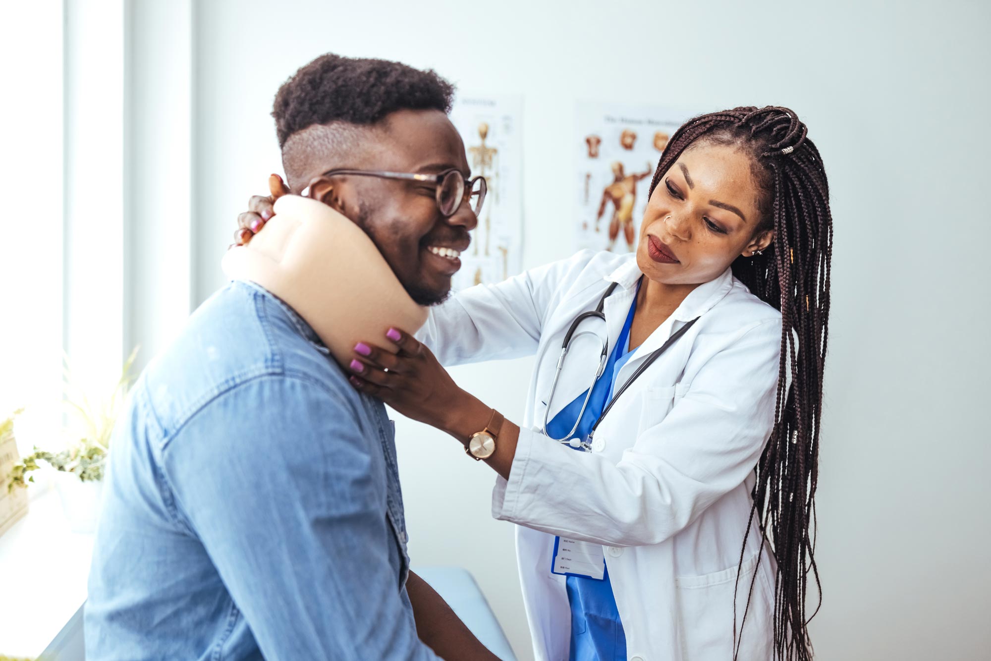 Doctor examining a patient's neck in a medical office