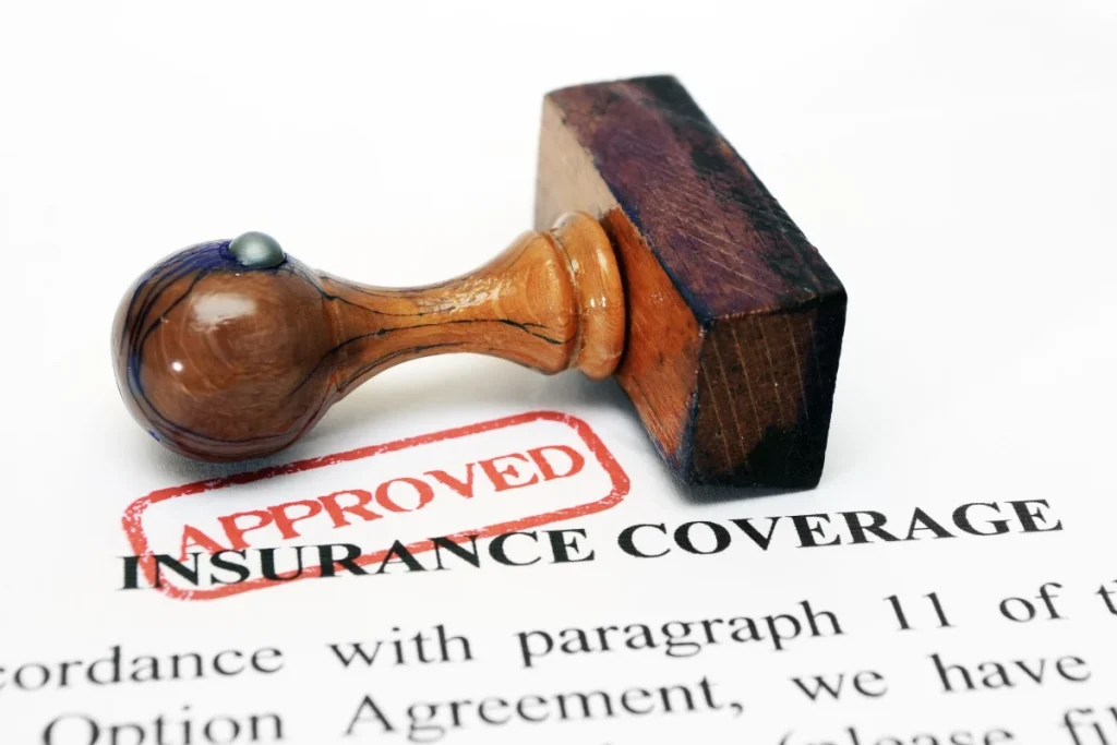 Stamp marking an approved insurance coverage document, representing car accident insurance claims, insurance claim process for car accidents, and filing a claim in Florida.